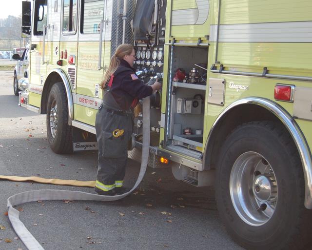 FF Mary Bausch connects a 2 1/2&quot; hose during the live burn drill November 18, 2012.